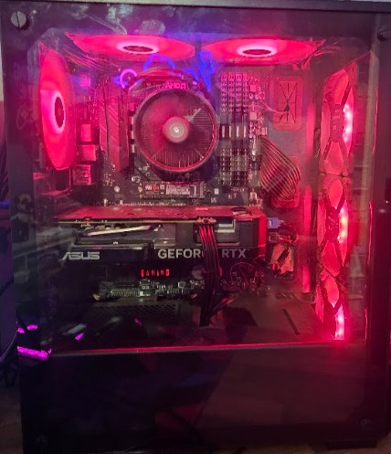 The inside of my desktop PC build, with red lit fans and an ASUS GeForce RTX graphics card